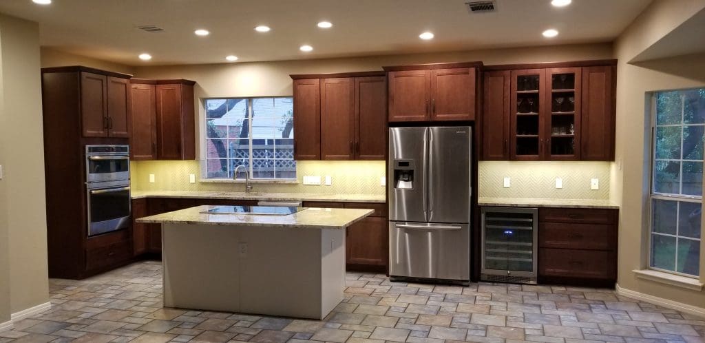 A modern kitchen featuring a large island and sleek stainless steel appliances.